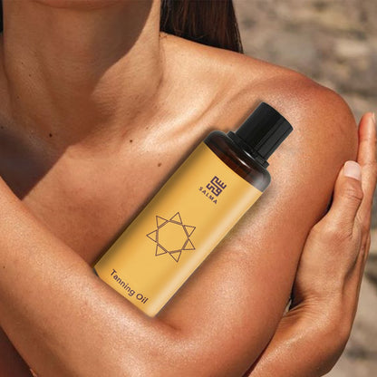 Bottle of Salma Loves Beauty tanning oil for shimmer and hydration